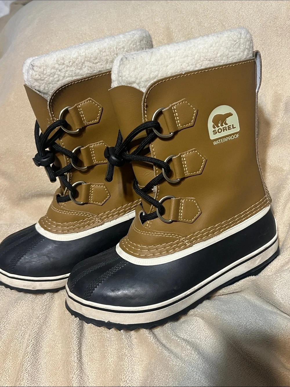 Sorel kids Tan and Black Waterproof Snow Boot with White Fleece Cuff- size 1